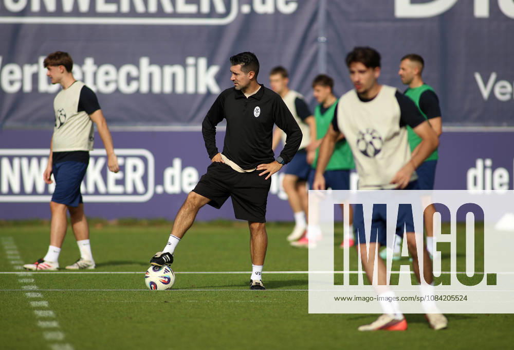 Soccer, Men s, Bavarian Regional League, 2026–2027 Season, TSV 1860 Munich, Practice, Grünwalder Strasse 114 Alper Kayabunar, coach of TSV 1860 Munich, standing on the practice field with one foot on the ball, watches his players