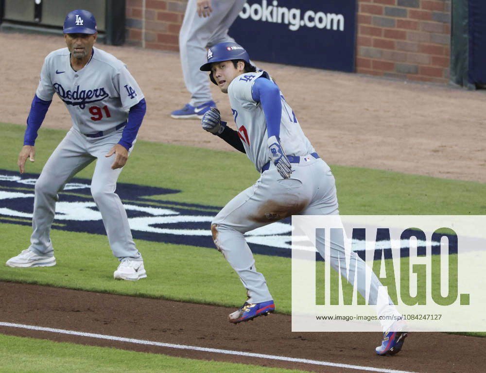 Baseball: Division Series between Dodgers and Braves Los Angeles Dodgers designated hitter Shohei Ohtani (R) heads home on an error by the Atlanta Braves as third base coach Dino Ebel (91) watches during the second inning of Game 4 of the National League Division Series at Truist Park in Atlanta on Oct. 7, 2026. A14AA0005630406P