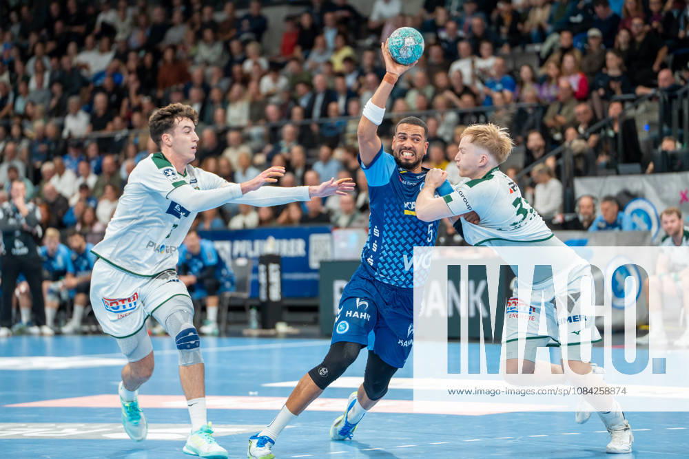 Handball I Men I 2026–2027 Season I Bundesliga I Matchday 8 I TVB Stuttgart vs. HSG Wetzlar I October 8, 2026 Philipp Ahouansou 5, TVB Stuttgart with the ball, defended by Marti Soler Biescas 23, HSG Wetzlar and Georg Löwen 33, HSG Wetzlar; Stuttgart Porsche Arena, Baden-Württemberg, Germany