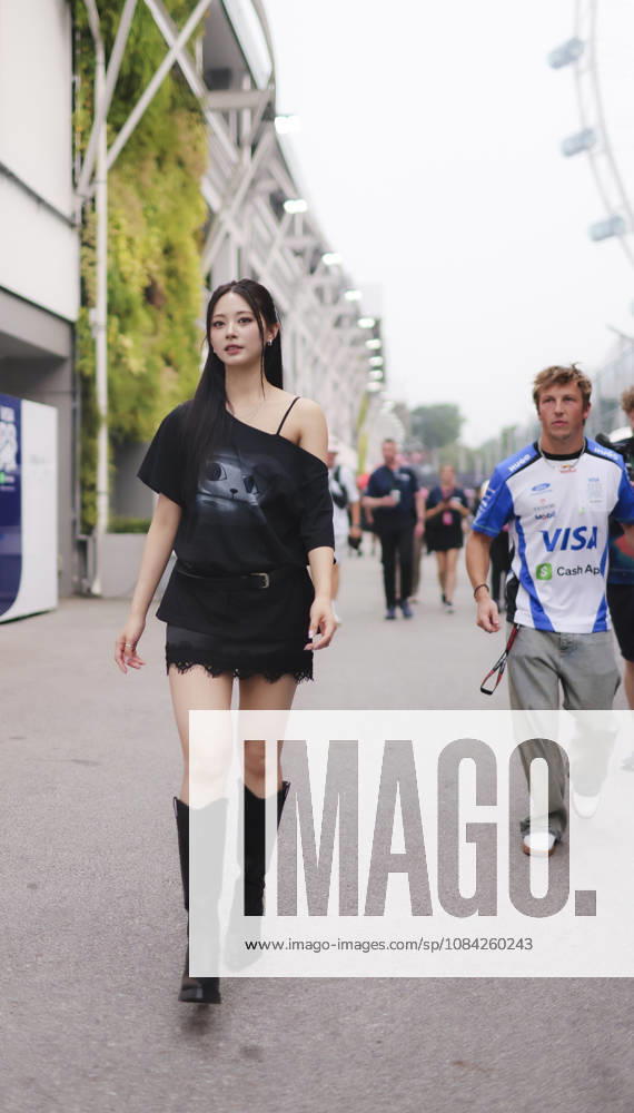 LIAM LAWSON of Oracle Red Bull Racing approaches TZUYU (CHOU TZU-YU), Taiwanese member of K-pop girl group TWICE, to greet her during her visit to the Williams Racing paddock ahead of the 2026 Formula 1 Singapore Grand Prix at Marina Bay Street Circuit in Singapore. Singapore Singapore - ZUMAh201 20261008_zsp_h201_029