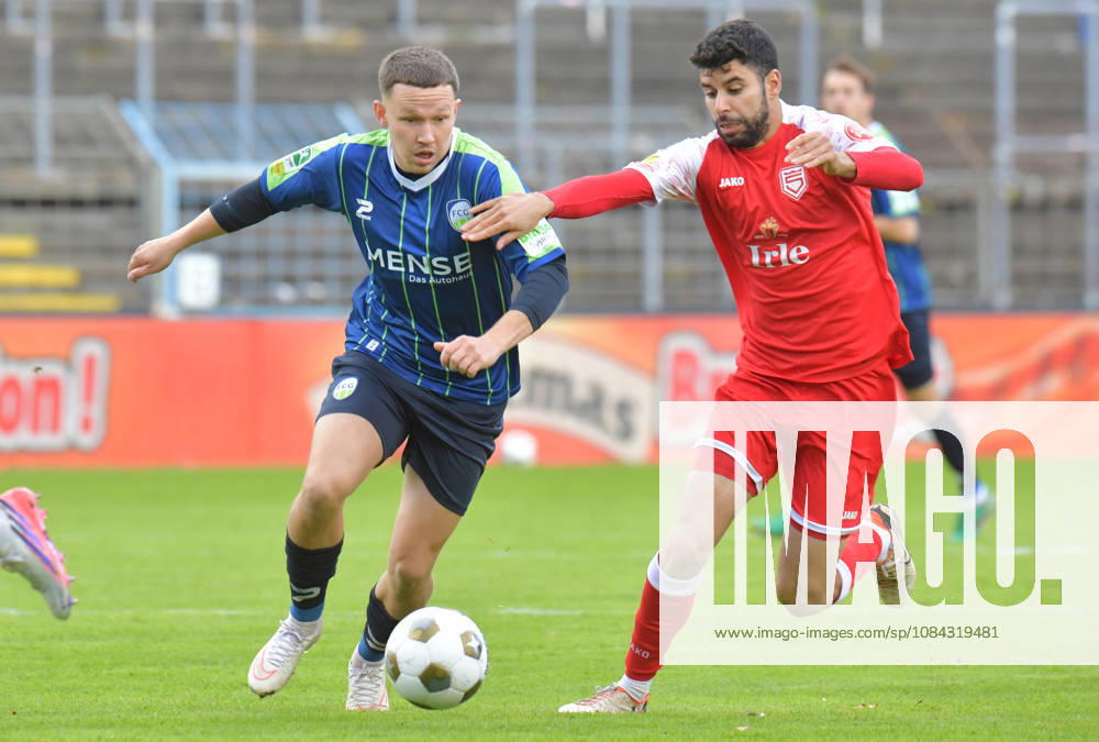Germany, Soccer, Regionalliga West, 2026–2027 Season, Matchday 12, Ohlendorf Stadium in Heidewald, Gütersloh FC vs. SF Siegen 0–5, Phil Beckhoff (FC Gütersloh, left) vs. Hamza Saghiri (SF Siegen), action, duel, tackle