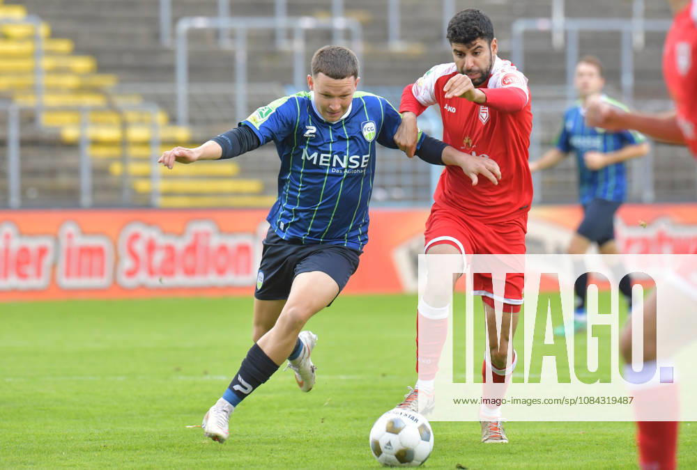 Germany, Soccer, Regionalliga West, 2026–2027 Season, Matchday 12, Ohlendorf Stadium in Heidewald, Gütersloh FC vs. SF Siegen 0–5, Phil Beckhoff (FC Gütersloh, left) vs. Hamza Saghiri (SF Siegen), action, duel, tackle