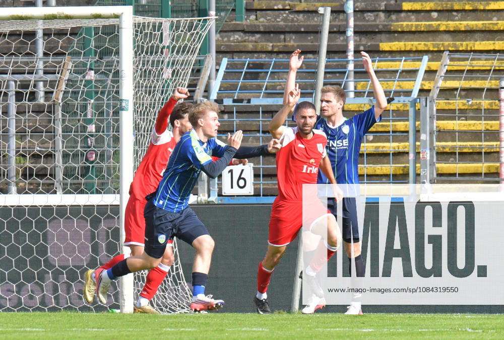 GER, Soccer, Regionalliga West, 2026–2027 Season, Matchday 12, Ohlendorf Stadium in Heidewald, Gütersloh FC vs. SF Siegen 0–5 Goal celebration: SF Siegen goal scorer Serhat Semih Güler; SF Siegen celebrates the 0–2 goal, Erik Lanfer (FC Gütersloh) protests a handball call; action; still frame; wide shot; facial expressions; gestures; celebration; cheering; joy; delight