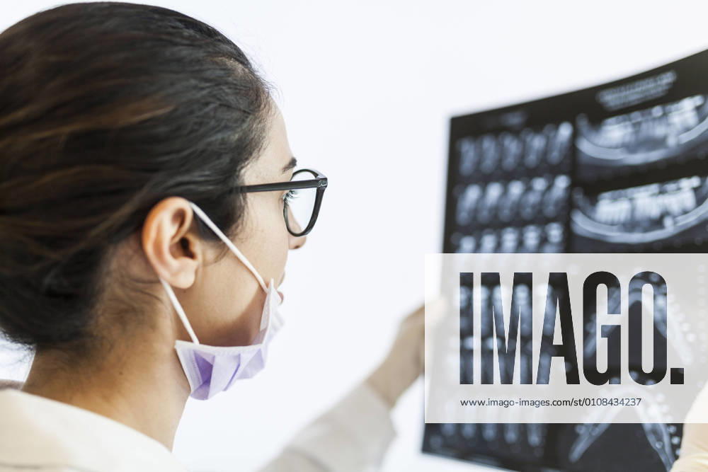 Female dentist reviewing the patient s x-ray, Model released