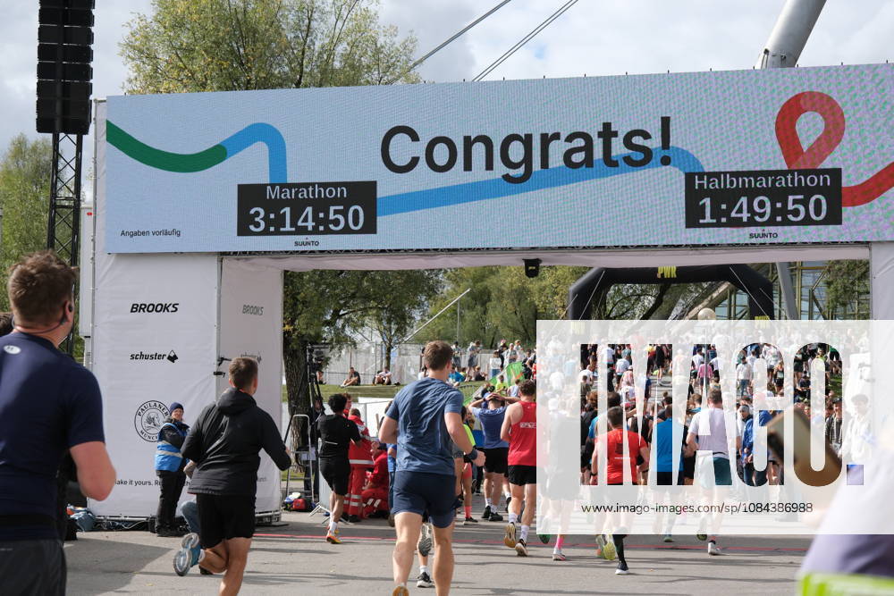 Munich Marathon 2026 MUNICH, GERMANY - OCTOBER 11: Runners cross the finish line under a large digital scoreboard displaying congratulations and race times during the 2026 Munich Marathon in Munich, Germany on October 11, 2026. The finish line is located in the Olympic Park, where the course both starts and ends. Merve Goettl Anadolu Munih Germany. Editorial use only. Please get in touch for any other usage.