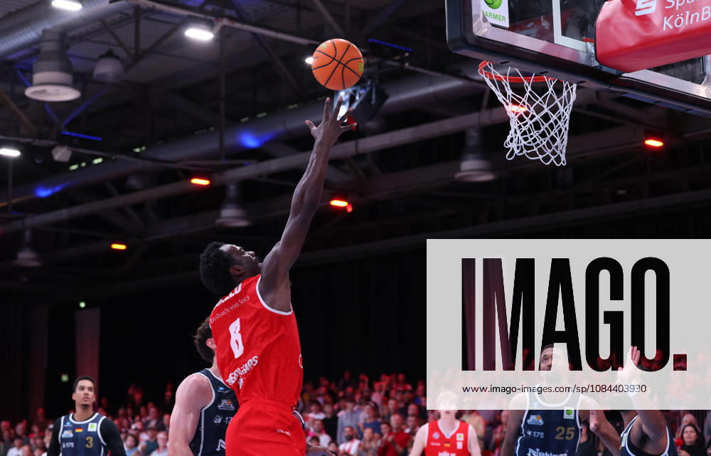 Nat Diallo of RheinStars Cologne 08 shooting a basket; Garai Zeeb of Eisbären Bremerhaven 03 and Jeremiah Oden of Eisbären Bremerhaven 25 watching; GER, RheinStars Cologne vs. Eisbären Bremerhaven, Basketball, ProA, Matchday 4, 2026–2027 season, October 11, 2026 GER, RheinStars Cologne vs. Eisbären Bremerhaven, Basketball, ProA, Matchday 4, 2026–2027 season, October 11, 2026, RheinStars Cologne