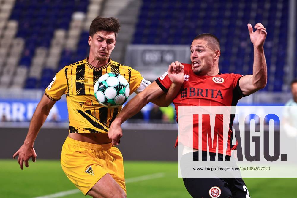 Danilo Wiebe of Alemannia Aachen, 28, in a tackle with Marcus Mueller of SV Wehen Wiesbaden, 21 (GER), SV Wehen Wiesbaden vs. Alemannia Aachen, soccer, 3rd Division, Matchday 9, 2026–2027 season, October 14, 2026 DFB regulations prohibit any use of photographs as image sequences and or quasi-video GER, SV Wehen Wiesbaden vs. Alemannia Aachen, soccer, 3rd Division, Matchday 9, 2026–2027 season, October 14, 2026, Wiesbaden