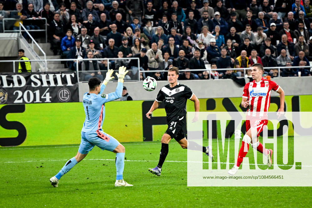 LUGANO, SWITZERLAND OCTOBER 15 Kevin Behrens of FC Lugano attempts to score against goalkeeper Matheus Magalhaes of FK Crvena Zvezda during the UEFA Conference League 2026–27 League Phase Matchday 1 game between FC Lugano and FK Crvena Zvezda at the Lugano Arena on October 15, 2026, in Lugano, Switzerland; Lugano, Lugano Arena, Ticino, Switzerland