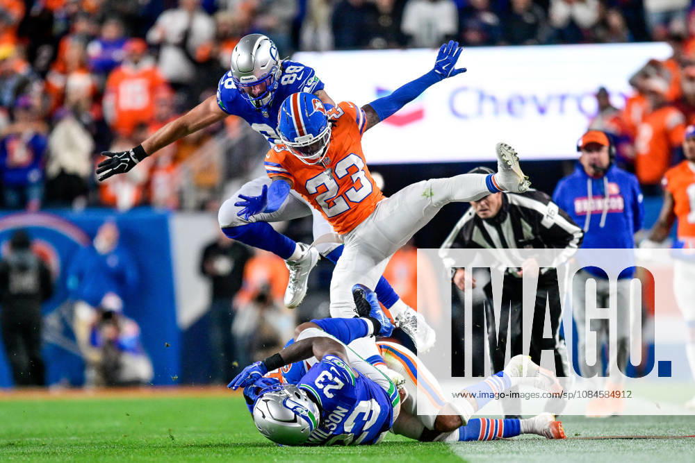 DENVER, CO - OCTOBER 15: Denver Broncos cornerback Jahdae Barron (23) and Seattle Seahawks tight end AJ Barner (88) fly through the air after a tackle of running back Emanuel Wilson (23) during a game between the Seattle Seahawks and the Denver Broncos at Empower Field at Mile High on October 15, 2026 in Denver, Colorado. (Photo by Dustin Bradford Icon Sportswire) NFL, American Football Herren, USA OCT 15 Seahawks at Broncos Icon132261015022