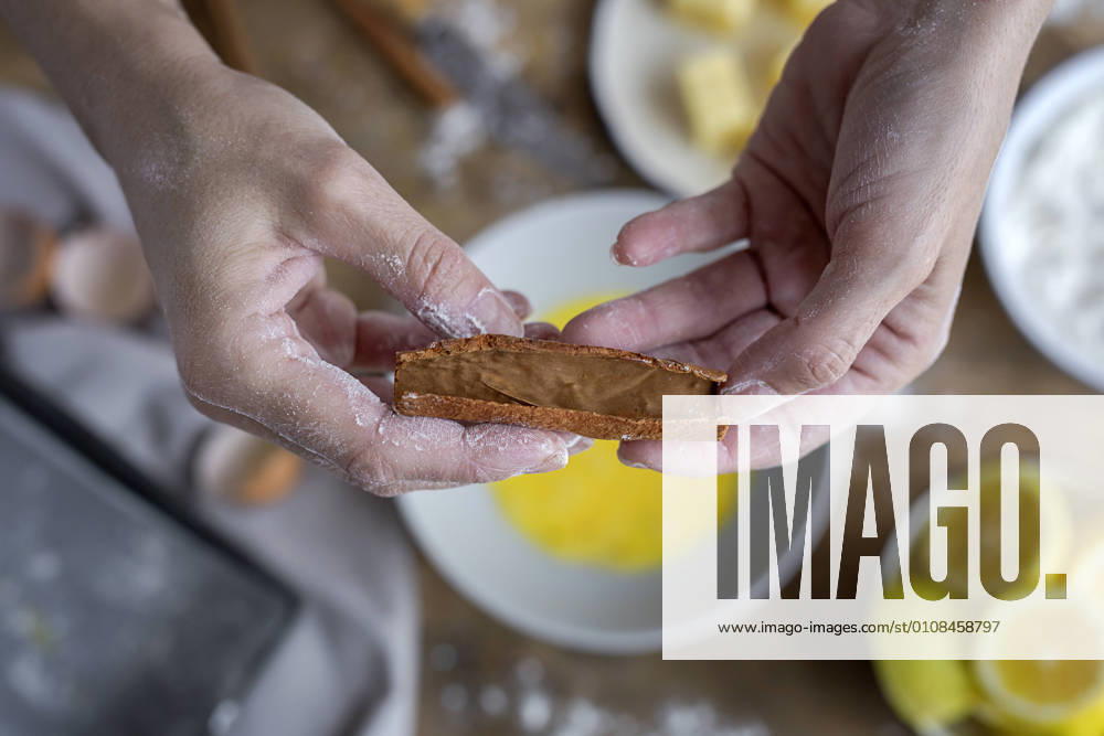 IMAGO Creative: Clickbait, Rezepte und Kochen From above top view of crop anonymous woman showing cinnamon on wooden table with flour butter and lemon ingredients for cake on the background