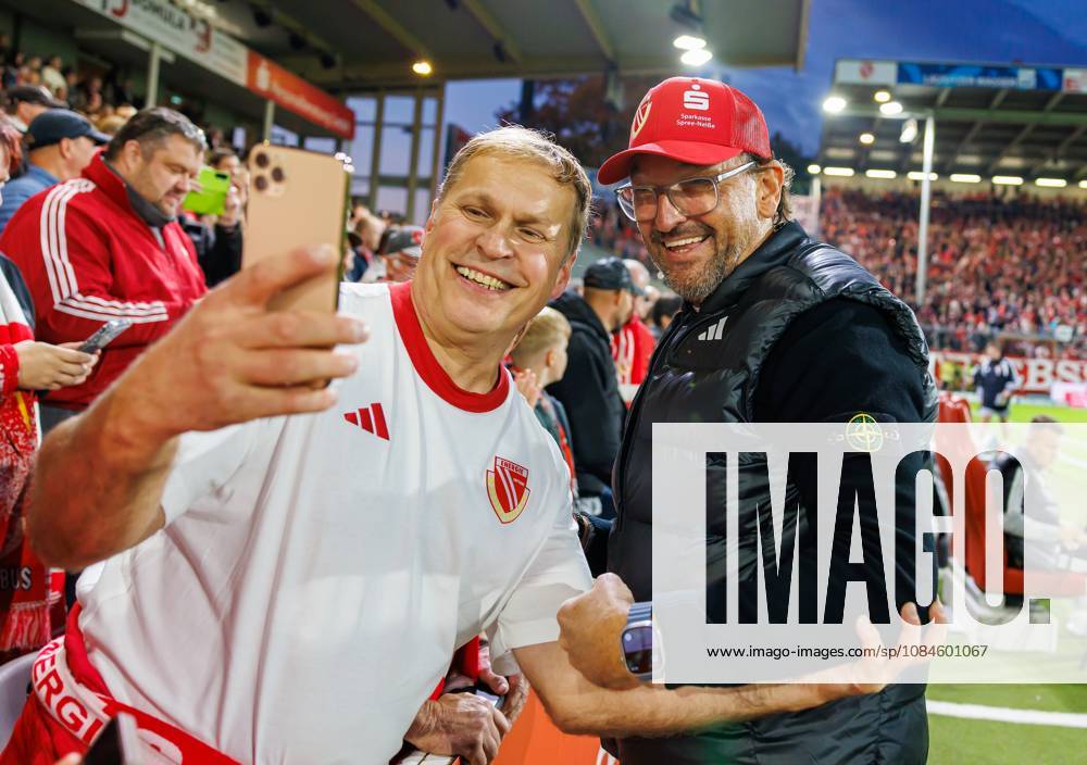 Soccer Season 2026–2027 Matchday 2 Bundesliga FC Energie Cottbus (FCE 1) vs. FC Nürnberg (FCN) Club Sports Photo by Zink DaMa DFL regulations prohibit any use of photographs as image sequences and or quasi-video for editorial use only; Claus Dieter Wollitz, coach of Energie Cottbus, takes selfies with spectators, the crowd, and fans