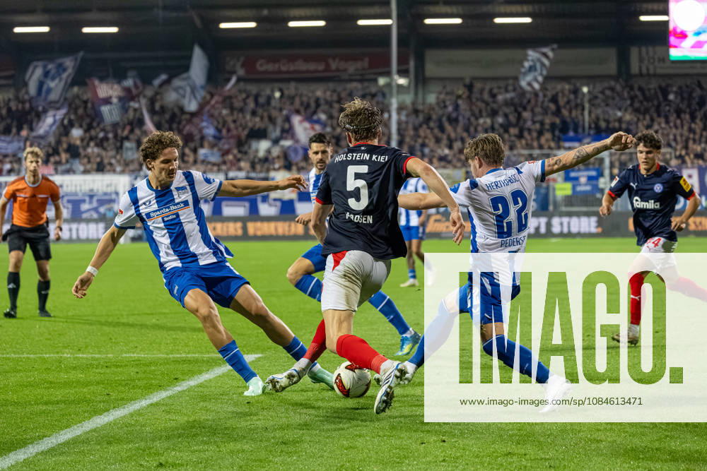 Soccer 2. Bundesliga Men s 2026–2027 Season, Matchday 8: Holstein Kiel vs. Hertha BSC (Kiel in dark blue), Berlin in white with blue stripes; from left to right: Soufian Gouram, Noah Madsen, Mads Pedersen; Holstein Kiel Stadium, Westring 501, Schleswig-Holstein, Germany