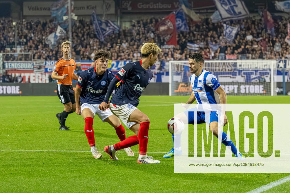 Soccer 2. Bundesliga Men s 2026–2027 Season, Matchday 8: Holstein Kiel vs. Hertha BSC (Kiel in dark blue), Berlin in white and blue stripes; from left to right: Mark Richter, Hiroki Sekine, Josip Brekalo; Holstein Kiel Stadium, Westring 501, Schleswig-Holstein, Germany