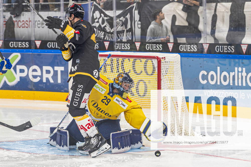 LUGANO, SWITZERLAND OCTOBER 16: Davos goalkeeper Sandro Aeschlimann in action despite Zach Sanford of Lugano (L) in front of him during the game between HC Lugano and HC Davos at the Corner Arena on October 16, 2026, in Lugano, Switzerland. Lugano, Ticino, Switzerland