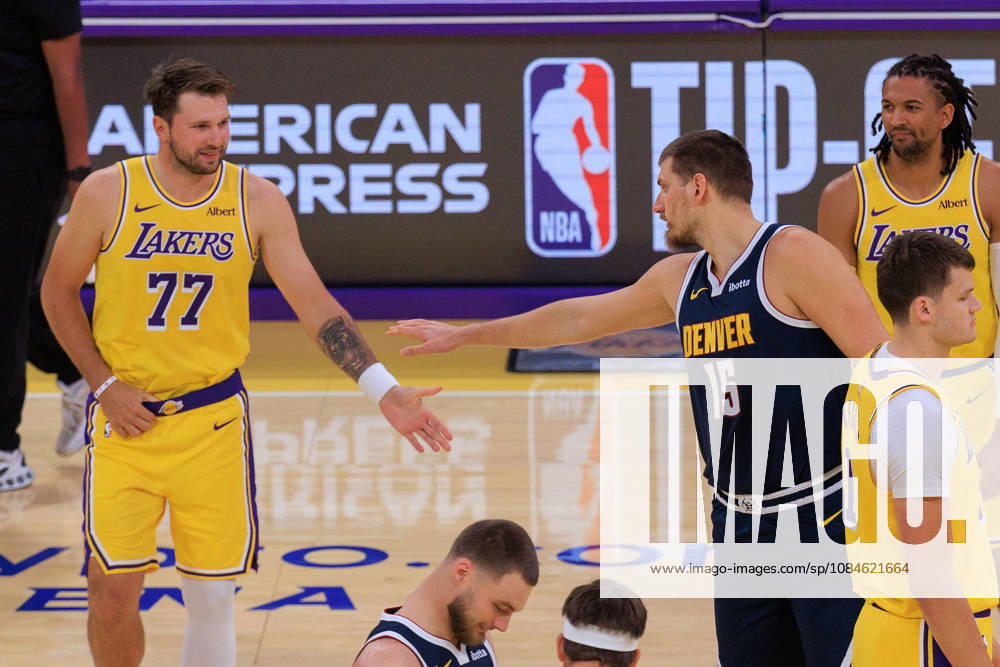 Luka Doncic 77 of the Los Angeles Lakers and Nikola Jokic 15 of the Denver Nuggets exchange greetings before the opening tip-off of a preseason NBA, Basketball Herren, USA game on Friday, October 16, 2026, at Crypto.com Arena in Los Angeles, California. JAVIER ROJAS PI Lakers Vs. Nuggets - Preseason - ZUMAp124 20261016_zaa_p124_004