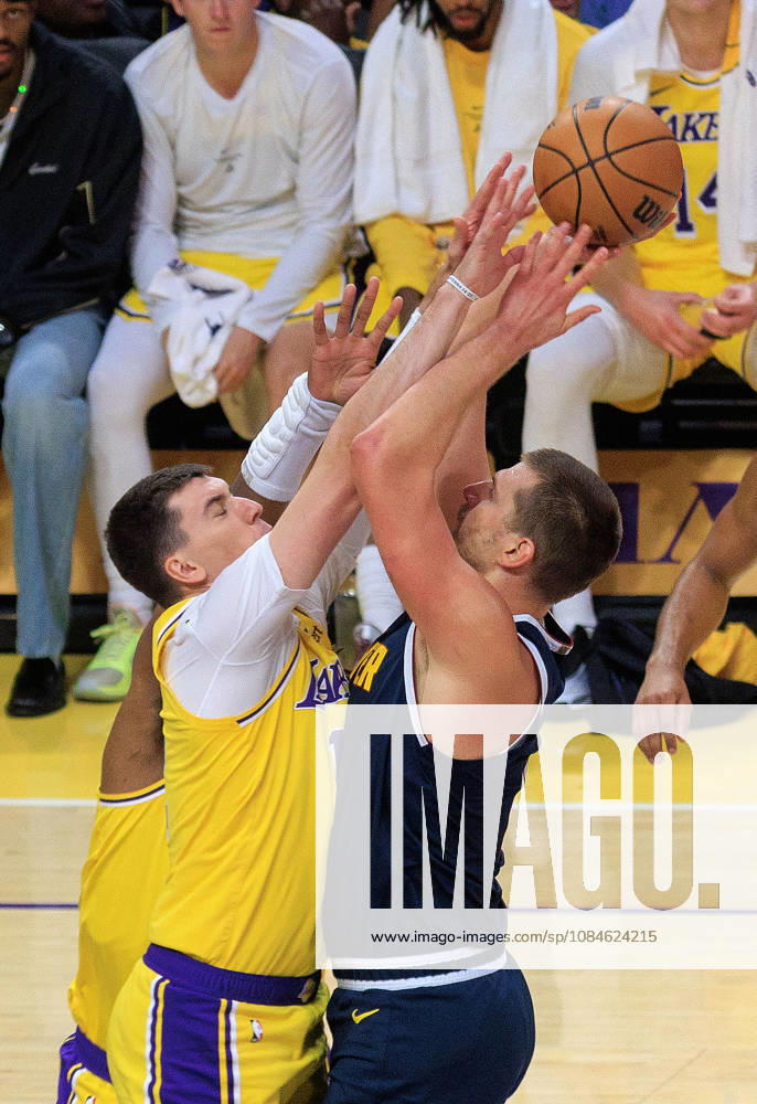 Jake LaRavia 12 of the Los Angeles Lakers blocks a shot by Nikola Jokic 15 of the Denver Nuggets during a preseason NBA, Basketball Herren, USA game on Friday October 16, 2026 at Crypto.com Arena in Los Angeles, California. Lakers lose to Nuggets, 106-121. JAVIER ROJAS PI Lakers Vs. Nuggets - Preseason - ZUMAp124 20261016_zaa_p124_052