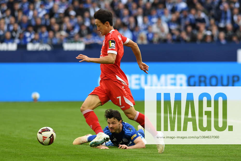 Jae-sung Lee of 1. FSV Mainz 05 and Adrian Gantenbein of FC Schalke 04 go head-to-head during the Bundesliga match between FC Schalke 04 and 1. FSV Mainz 05, Veltins Arena on October 17, 2026, in Gelsenkirchen, Germany. Photo by Ralf Treese, DeFodi Images. Jae-sung Lee of 1. FSV Mainz 05 and Adrian Gantenbein of FC Schalke 04 battle for the ball during the Bundesliga match between FC Schalke 04 and 1. FSV Mainz 05 at Veltins Arena on October 17, 2026 in Gelsenkirchen, Germany. Photo by Ralf Treese, DeFodi Images. DFB and DFL regulations prohibit any use of photographs as image sequences and or quasi-video. Photo by Ralf Treese, DeFodi Images