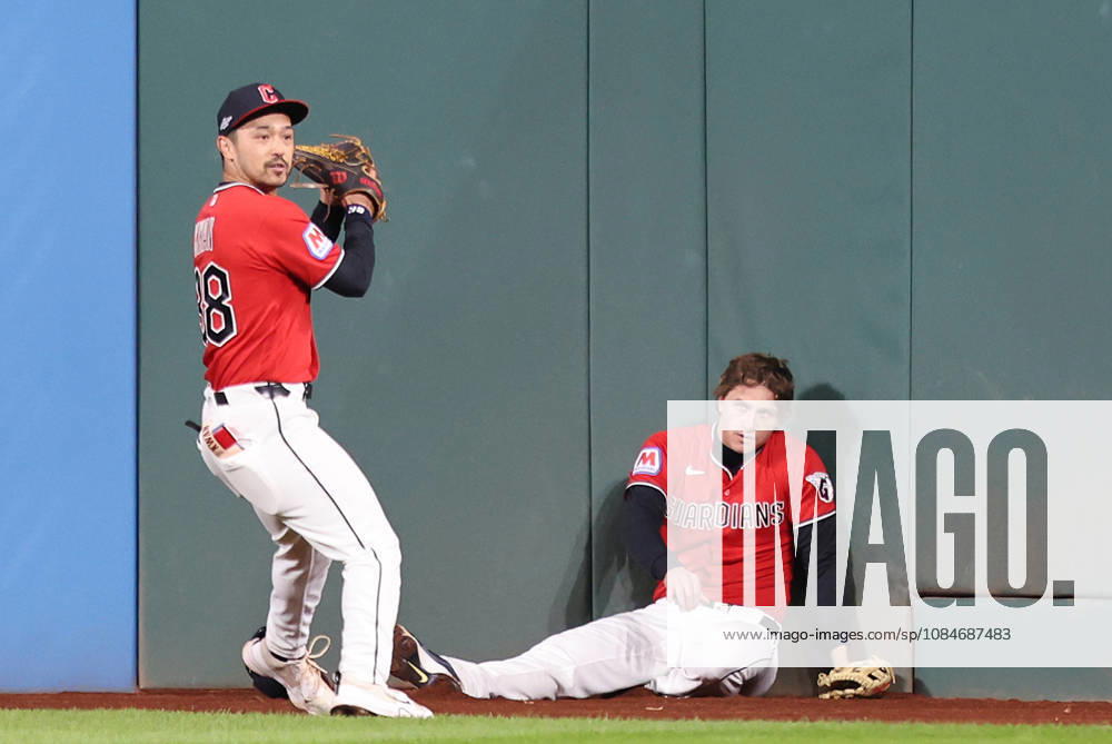 Cleveland Guardians center fielder Petey Halpin (R) sits on the ground after going up against the wall to catch a long fly ball from Tampa Bay Rays Junior Caminero as left fielder Steven Kwan (38) assists in the fourth inning during game four of the MLB, Baseball Herren, USA American League Championship Series at Progressive Field in Cleveland, Ohio, on Saturday, October 17, 2026. CLE20261017715 AARONxJOSEFCZYK