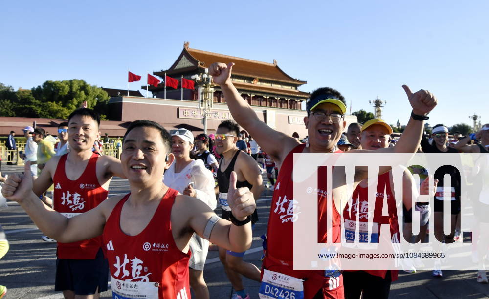 (261018) -- BEIJING, Oct. 18, 2026 -- Runners waves to cameras as they compete during the 2026 Beijing Marathon & National Marathon Championships in Beijing, capital of China, Oct. 18, 2026. ) (SP)CHINA-BEIJING-2026 BEIJING MARATHON(CN) LixXin