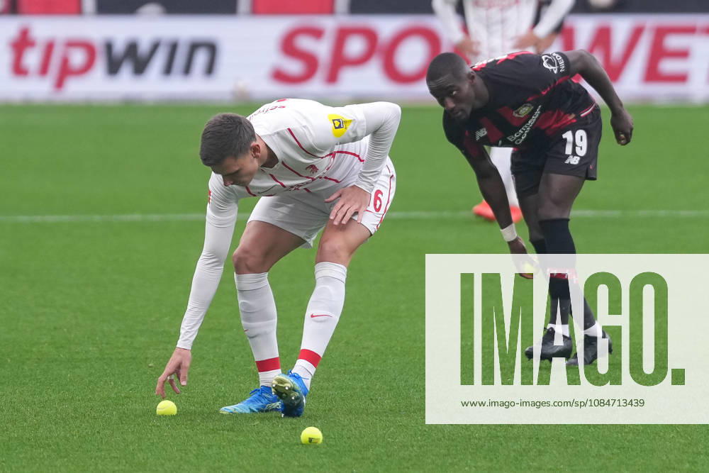 Yannik Engelhardt of SC Freiburg, 16, and Moussa Diaby of Bayer 04 Leverkusen, 19, pick up tennis balls; Freiburg fans and ultras protest by throwing tennis balls onto the field; game interrupted; Germany, soccer, 1. Bundesliga, Matchday 6, 2026–2027, Bayer Leverkusen vs. SC Freiburg, October 18, 2026, BayArena, Leverkusen, BayArena, North Rhine-Westphalia, Germany