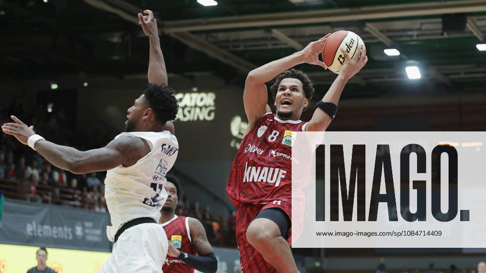 Pictured from left: Anthony Gaines of Syntainics MBC, No. 11, against Brandon Tischler of Wuerzburg Baskets, No. 8, on a layup, 18 10 2026, Fitness First Wuerzburg Baskets vs. SYNTAINICS MBC, Netto BBL Cup, Round of 16, Germany, 97072, tectake Arena Wuerzburg,