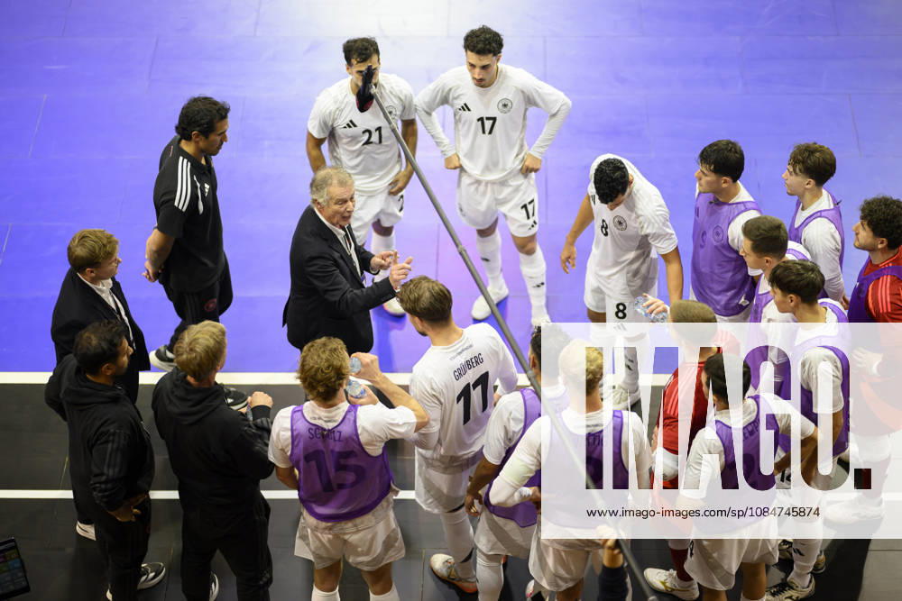 National team coach Marcel Loosveld (GER) gives instructions during a timeout, gesturing, surrounded by players during the Futsal World Cup qualifying match between Germany and Lithuania (4–2) on October 18, 2026, at the Westenergie Sporthalle in Mülheim an der Ruhr, Germany