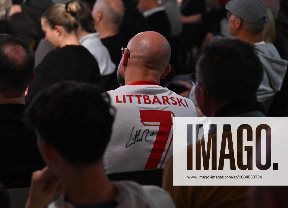Cologne, German Olympic Sports Museum: An evening with World Cup champions Thomas Häßler and Pierre Littbarski; audience member wearing a Littbarski jersey, Cologne