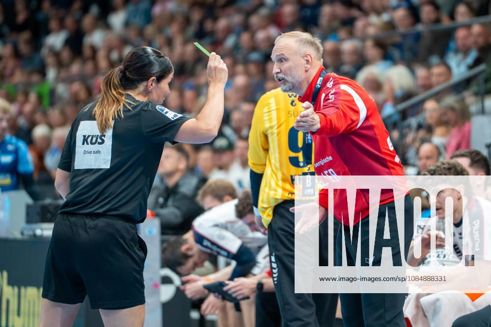 Handball I Men I 2026–2027 Season I Bundesliga I Matchday 10 I TVB Stuttgart vs. SG BBM Bietigheim I October 22, 2026 Hartmut Mayerhoffer, Coach, SG BBM Bietigheim receives a yellow card from the refereeing team of Kuttler and Merz at the Stuttgart Porsche Arena in Baden-Württemberg, Germany