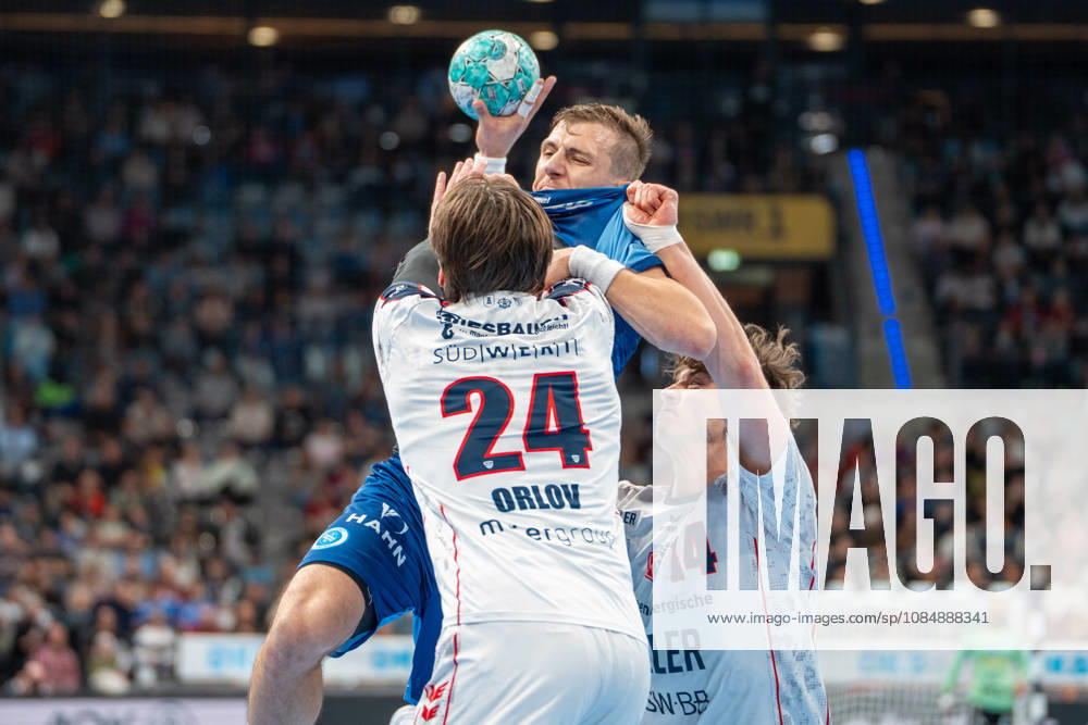 Handball I Men I 2026–2027 Season I Bundesliga I Matchday 10 I TVB Stuttgart vs. SG BBM Bietigheim I October 22, 2026 Simone Mengon 15, TVB Stuttgart with the ball, defended by Maxim Orlov 24, SG BBM Bietigheim, and Fynn Luca Nicolaus 14, SG BBM Bietigheim; Stuttgart Porsche Arena, Baden-Württemberg, Germany