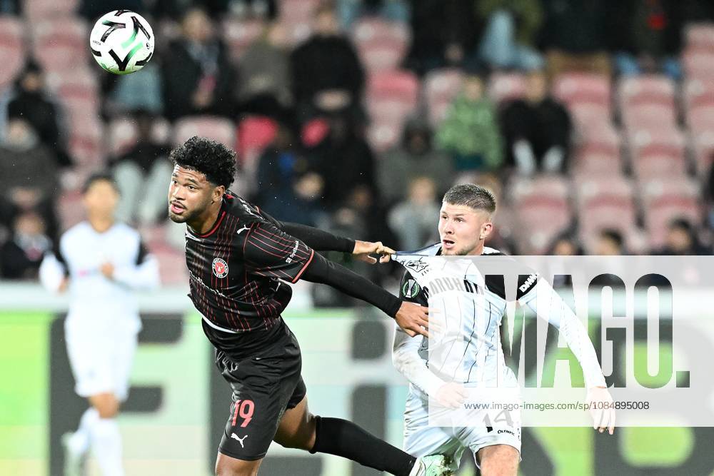 Midtjylland s Pedro Bravo and STVV s Ryan Merlen pictured in action during a soccer game between Danish FC Midtjylland and Belgian Sint-Truidense VV, Thursday 22 October 2026 in Herning, Denmark, on the second day of the UEFA Conference League league phase. JILLxDELSAUX x190692015x