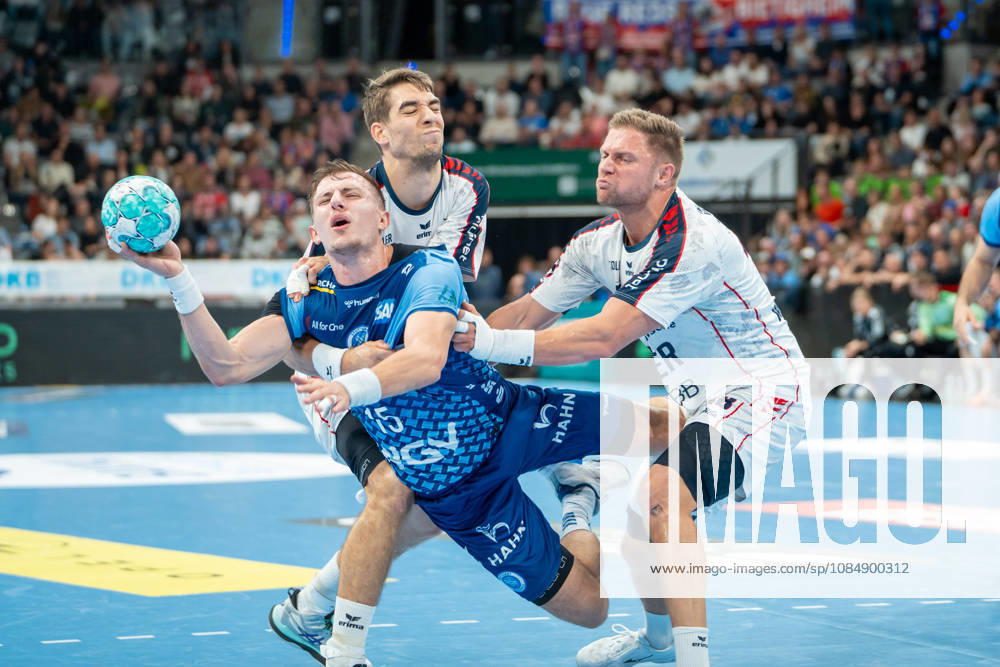Handball I Men I 2026–2027 Season I Bundesliga I Matchday 10 I TVB Stuttgart vs. SG BBM Bietigheim I October 22, 2026 Simone Mengon 15, TVB Stuttgart defended by Nikola Vlahovic 3, SG BBM Bietigheim and Jonathan Fischer 36, SG BBM Bietigheim Stuttgart Porsche Arena Baden-Württemberg Germany