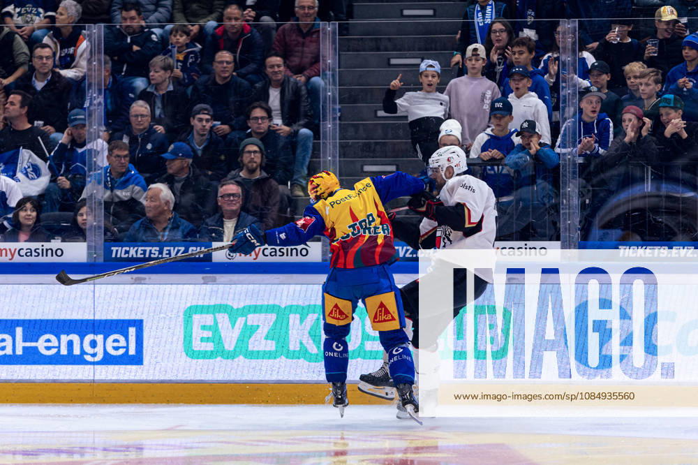 Check by top scorer Vinzenz Rohrer of EV Zug against Fabian Heldner 91 of Lausanne HC on October 23, 2026, National League, Regular Season, Ice Hockey, OYM Hall, Zug EV Zug vs. Lausanne HC Image by