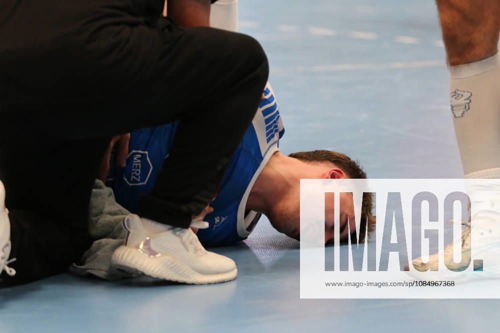 Men s Handball 2026–2027, 2nd Division, Matchday 9: Dessau Roßlauer HV 06 vs. SC DHfK Leipzig at Anhalt Arena, Dessau. Marcel Nowak, Dessau, 15, in blue, is lying on the ground after a rough foul and is receiving medical attention Dessau Roßlau Saxony-Anhalt Germany