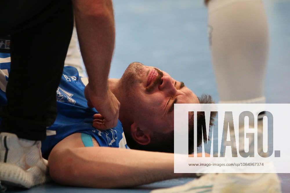 Men s Handball 2026–2027, 2nd Division, Matchday 9: Dessau Roßlauer HV 06 vs. SC DHfK Leipzig at Anhalt Arena, Dessau. Marcel Nowak, Dessau, 15, in blue, is lying on the ground after a rough foul and is receiving medical attention Dessau Roßlau Saxony-Anhalt Germany
