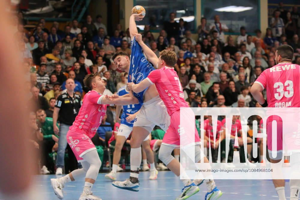 Men s Handball 2026–2027, 2nd Division, Matchday 9: Dessau Roßlauer HV 06 vs. SC DHfK Leipzig at Anhalt Arena, Dessau. Referee: Marcel Nowak (Dessau), 15, in blue, is stopped from taking a shot on goal by former Dessau players Fritz Leon Haake (Leipzig, 6, in pink) and Tim Hertzfeld (Leipzig, 72, in pink) Dessau Roßlau Saxony-Anhalt Germany