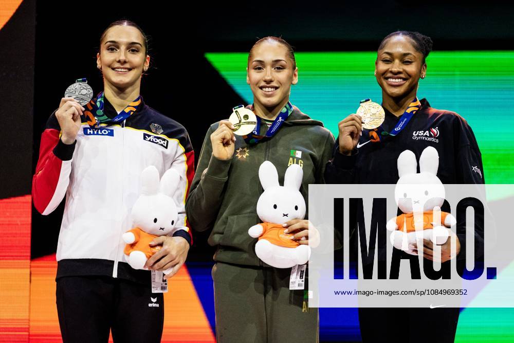 ROTTERDAM - Winner Kaylia Nemour (ALG) surrounded by Helen Kevric (GER) (r) (second) and Skye Blakely (USA) (third) during the medal ceremony of the uneven bars apparatus final at the World Gymnastics Championships in Rotterdam Ahoy. IRIS VAN DEN BROEK ANP ANPxSportx IVx 573488608 originalFilename: 573488608