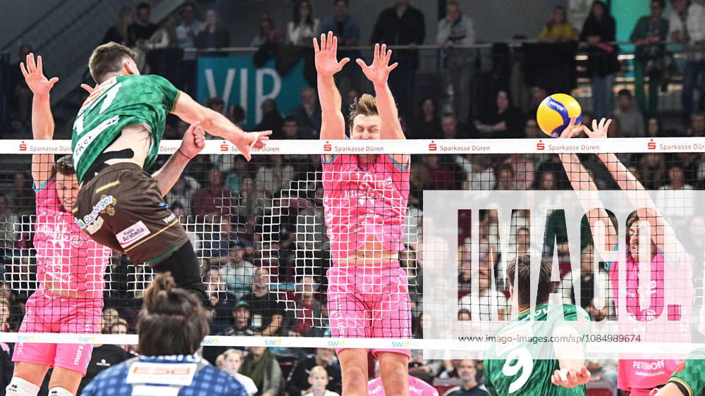 From left: Stijn van Schie (WWK Volleys Munich, No. 16) spikes the ball against the block set by Robert Viiber (Powervolleys Düren, No. 16) and Robin Baghdady (Powervolleys Düren, No. 8), 24, October 10, 2026, Düren, Germany, Volleyball, Men’s Bundesliga 1, Regular Season, SWD Powervolleys Düren vs. WWK Volleys Munich