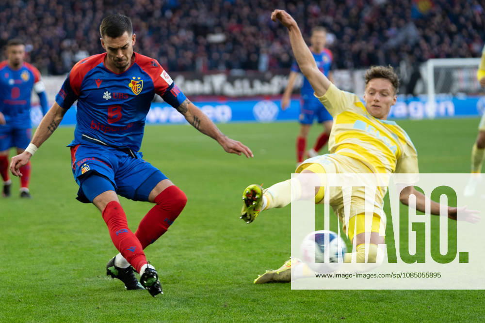 BASEL, SWITZERLAND, OCTOBER 24 — Clement Michelin of Basel (L) battles for the ball with Nikolas Muci of Grasshoppers (R) during the Swiss Super League match between FC Basel 1893 and Grasshopper Club Zurich at St. Jakob Park on September 20, 2026, in Basel, Switzerland