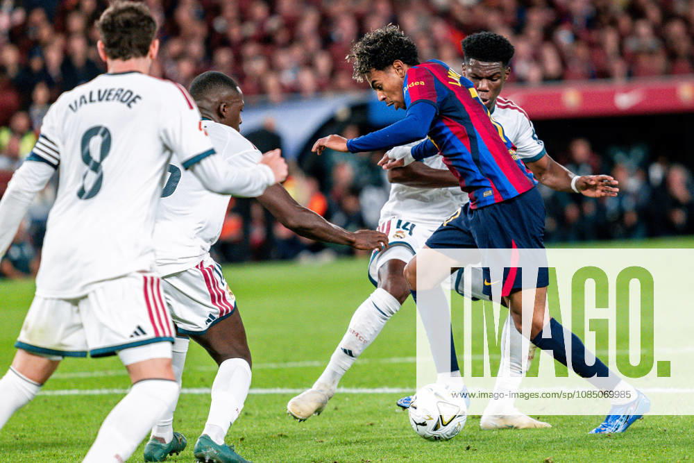IPA90183759 - Lamine Yamal 10 (F.C. Barcelona) in action against Tchouameni 14, Konate 16 and Valverde 8 (Real Madrid) during the 2026 La Liga EA Sports Championship soccer match between F.C. Barcelona and Real Madrid at Spotify Camp Now in Barcelona, Spain, on October 25, 2026