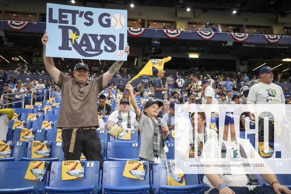 BILL JOHNSON, left, and his son, LIAM JOHNSON, 8, both of Raleigh, N.C., show their support for the Tampa Bay Rays during warmups before Game 3 of the World Series between the Tampa Bay Rays and the Milwaukee Brewers at Tropicana Field in St. Petersburg. St. Petersburg USA - ZUMAs70_ 20261026_zan_s70_033