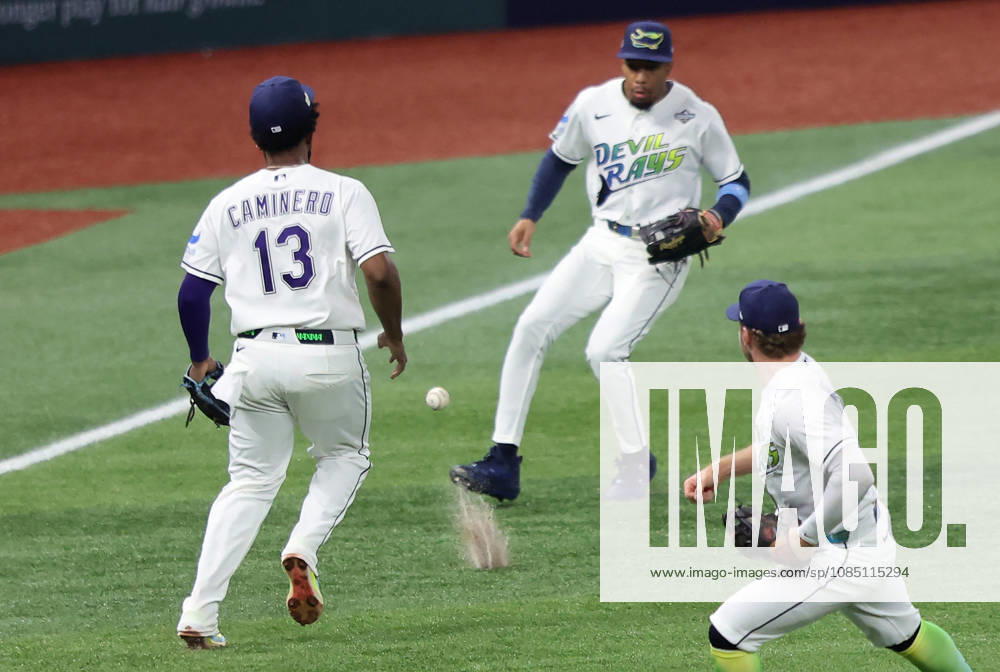 Tampa Bay Rays third baseman Junior Caminero (13) and left fielder Chandler Simpson (14) cannot reach a short fly ball from Milwaukee Brewers designated hitter Christian Yelich which drops for a single in the first inning during game three of the 2026 MLB, Baseball Herren, USA World Series at Tropicana Field in St Petersburg, Florida, on Monday, October 26, 2026. TPB20261026713 AARONxJOSEFCZYK