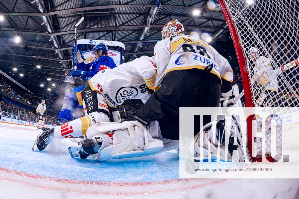 Goaltender Robert Mayer 88 of HC Lugano lets the puck from EV Zug s top scorer Vinzenz Rohrer pass between his legs, as seen from the NetCam perspective, October 27, 2026, National League, Regular Season, Ice Hockey, OYM Hall, Zug EV Zug HC Lugano Image by