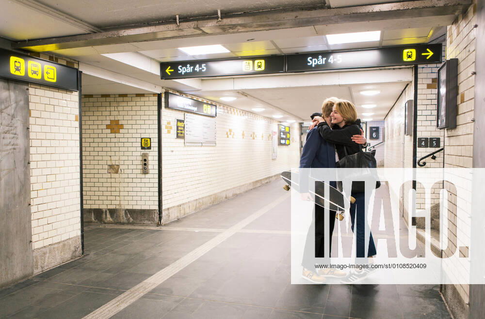 Full length of young couple embracing in underground walkway , model released