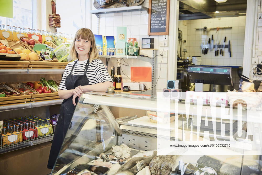 IMAGO Creative: Landleben - Essen Portrait of confident female owner standing by display cabinet in store , model released, property released