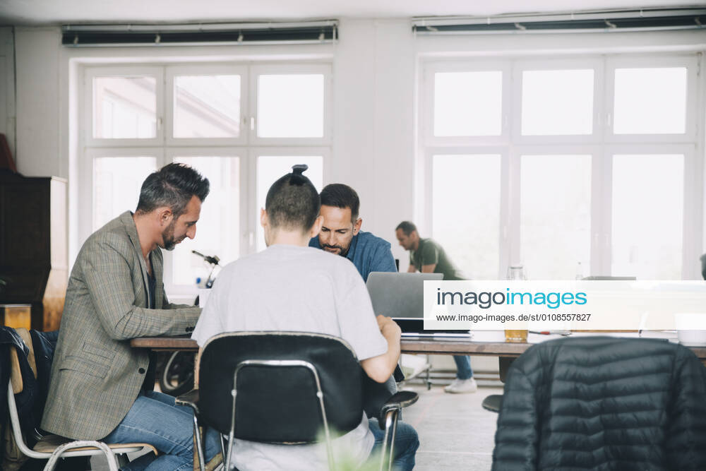 Creative business people working at table in office , model released, property released