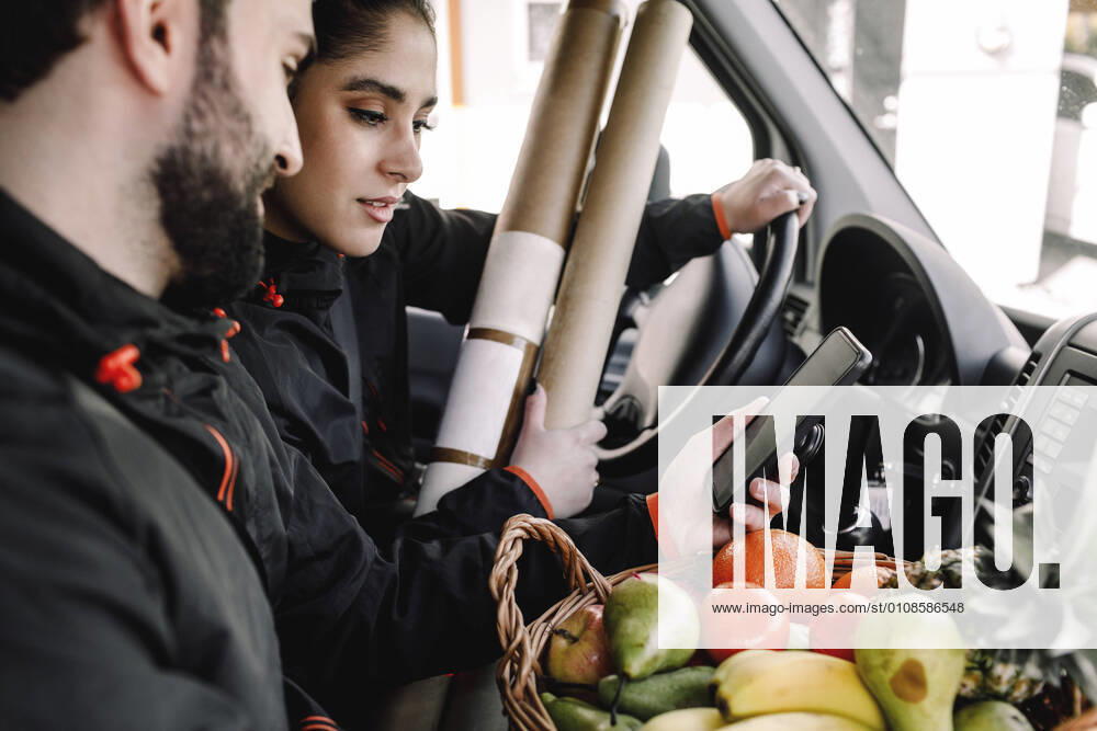 Delivery man and woman with fruits and packages in truck Sweden, Stockholm, model released