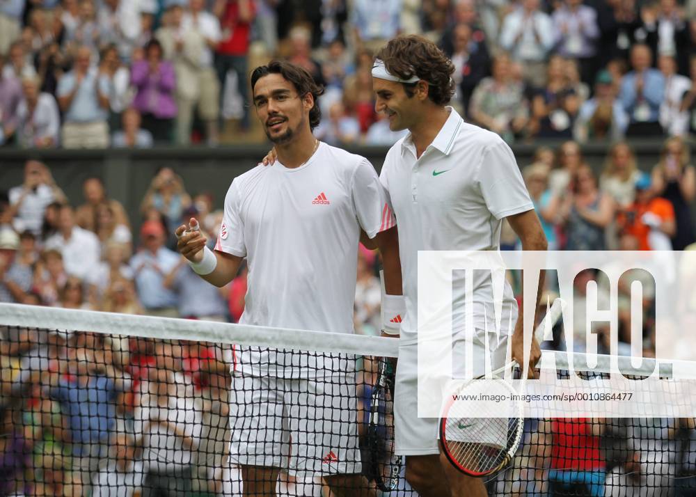 Swiss Roger Federer (R) consoles his opponent Italian Fabio Fognini on the third day of the 2012 Wimbledon championships in London, June 27, 2012. LON2012062719
