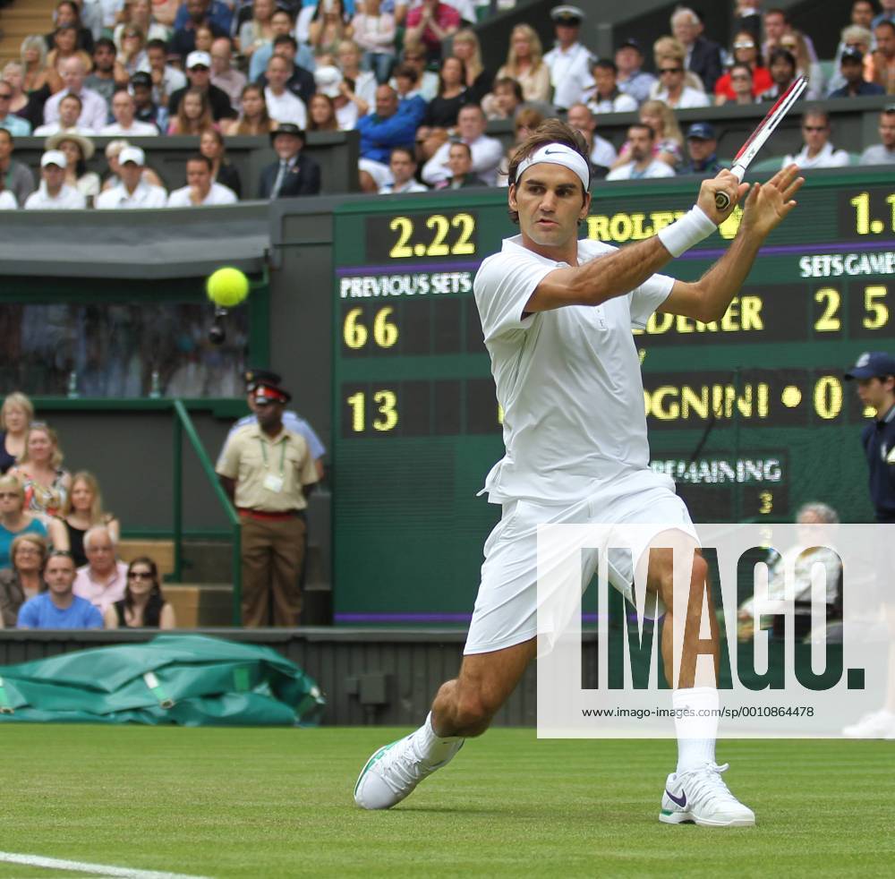 Swiss Roger Federer returns in his match on the third day of the 2012 Wimbledon championships in London, June 27, 2012. LON2012062721