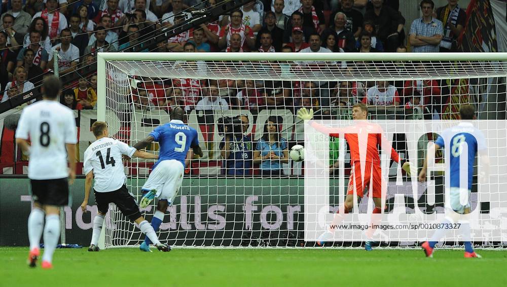 Mario Balotelli of Italy heads the opening goal during the Euro 2012 Semi-Final match at the National Stadium in Warsaw, Poland on June 28, 2012. WAR20120628109
