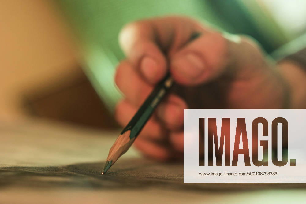 Close-up hand of unrecognizable person drawing with pencil., Model released